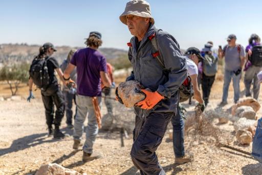Des militants juifs pour la paix enlèvent des obstacles afin de tenter de rouvrir une route bloquée par des colons israéliens dans le village palestinien de Jannatah, en Cisjordanie occupée,  au sud de Bethléem, le 25 août 2026. — Ilia YEFIMOVICH / AFP