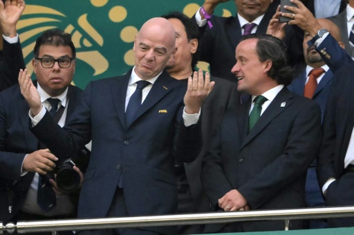 FIFA President Gianni Infantino (centre) has been forced to defend the decision to allow US striker Folarin Balogun to play against Belgium