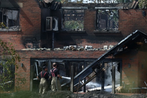 UK firefighters douse the smoldering ruins of a fire-damaged house, outside the central town of Stourbridge — Darren Staples / AFP