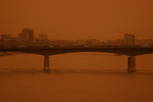 Vehicles crossing the Republic Bridge over the Tigris River in Baghdad during a dust storm in May 2026
