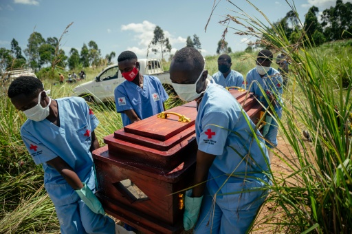 Des membres d'une équipe de la Croix-Rouge congolaise transportent le cercueil d'une femme qui serait décédée des suites de la maladie à virus Ebola lors de son enterrement dans les règles de sécurité dans un cimetière de Bunia, en RDC, le 7 juin 2026. — Jospin Mwisha / AFP