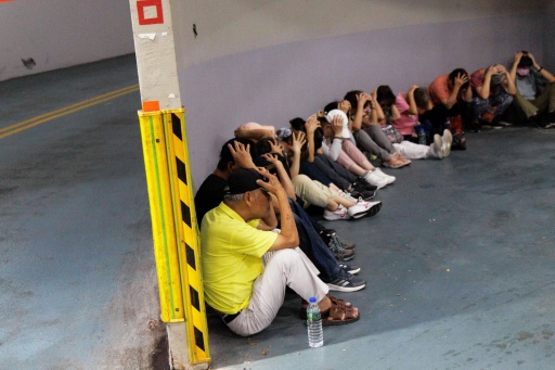 People take shelter in an underground subway station during a simulation attack in Taipei — CHENG Yu-chen / AFP