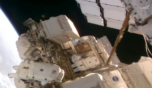 This frame grab from a NASA live video stream shows astronauts Anil Menon (L) and and Sophie Adenot (R) at the start of their spacewalk outside the International Space Station (ISS) — NASA / AFP