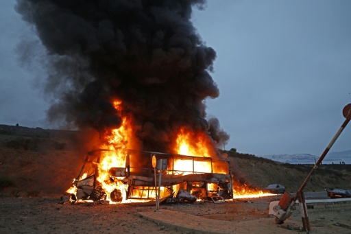 Fires engulfed dozens of cars including informal taxis in which these people had arrived the previous day — Abdel Majid BZIOUAT / AFP