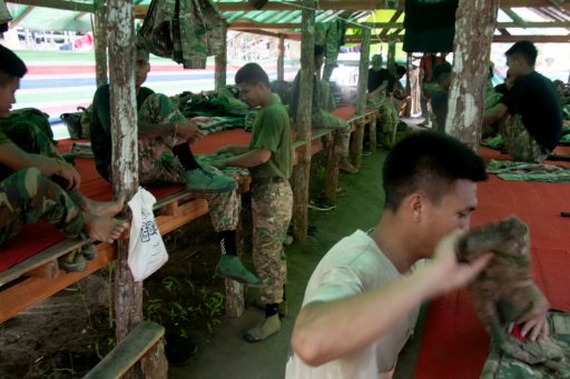 Des membres des PDF de Mandalay durant un temps libre dans un camp d'entraînement secret la région de Sagaing, dans le nord de la Birmanie le 19 mai 2026