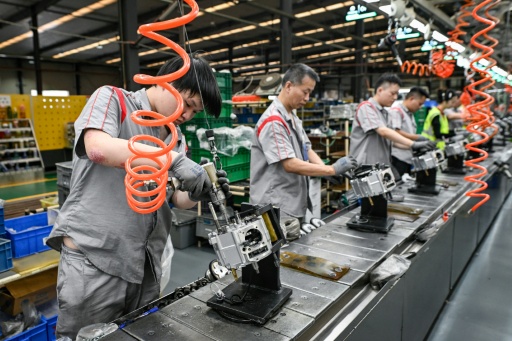 While many Chinese cities are now dominated by electric scooters, Chongqing has remained open to petrol-powered two-wheelers — WANG Zhao / AFP