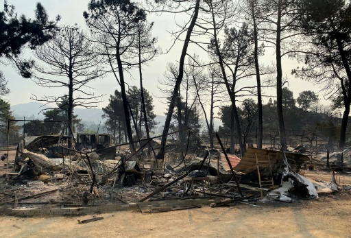 The fire left the campsite a mess of charred wreckage and twisted metal — Roland LLOYD PARRY / AFP
