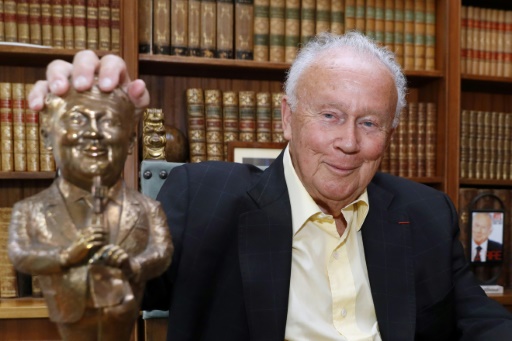 Philippe Bouvard pose avec une statuette le représentant, le 31 août 2016 à Paris — PATRICK KOVARIK / AFP