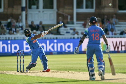 India's Rohit Sharma (L) hits out on his way to 138 in the third ODI against England at Lord's — Glyn KIRK / AFP