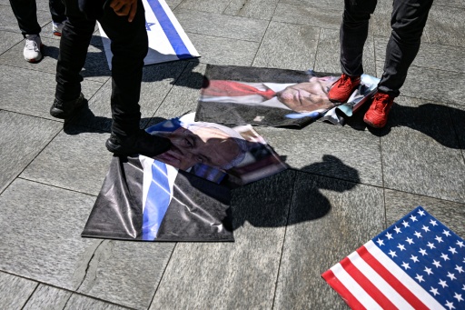 Des manifestants piétinent des photos du président américain Donald Trump et du Premier ministre israélien Benjamin Netanyahu, le 24 juillet 2026 à Caracas — Maxwell BRICENO / AFP