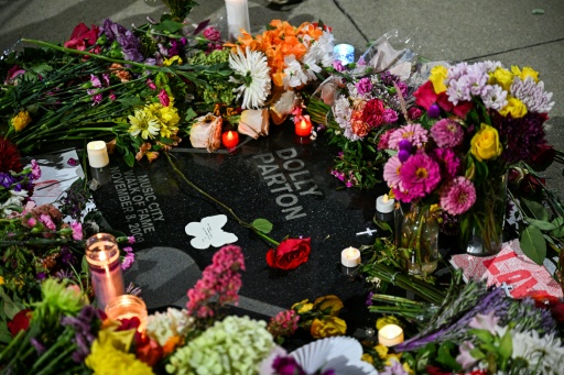 Flowers and candles cover Dolly Parton's star on The Music City Walk of Fame in Nashville, Tennessee — CHANDAN KHANNA / AFP