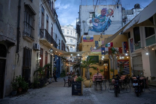 Empty tables at a restaurant in Old Havana are seen amid a lack of tourists and an exodus of residents deeply uncertain about Cuba's future — Pablo PORCIUNCULA / AFP