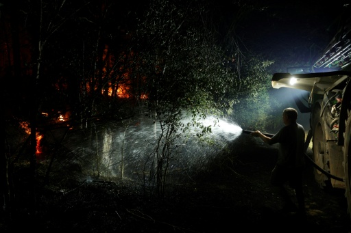 Local farmers in tractors tugged water cisterns to areas on fire, then aimed hoses towards the blaze
