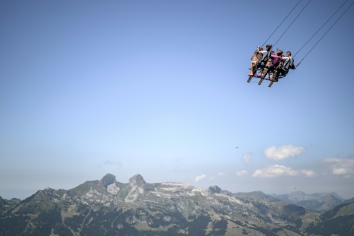 The ride draws screams and curses from participants — Fabrice COFFRINI / AFP