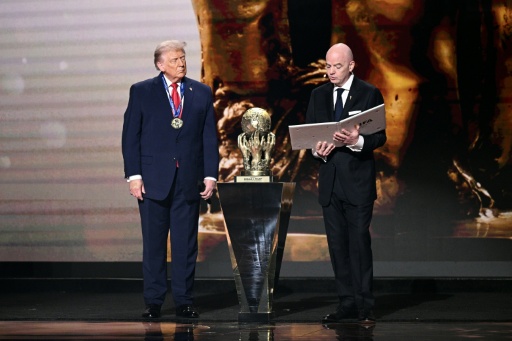 US President Donald Trump (left) receives the FIFA Peace Prize Gianni Infantino at the draw for the 2026 World Cup at the Kennedy Center, in Washington, in December 2025 — Brendan SMIALOWSKI / AFP
