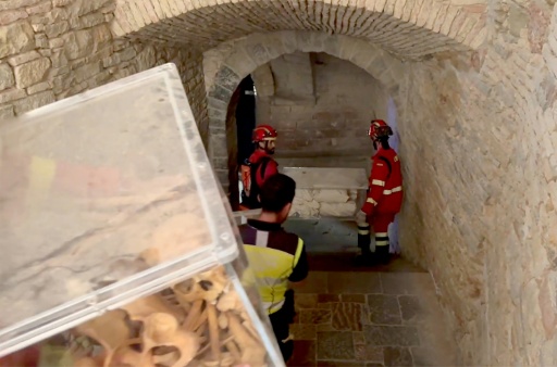 This screen grab from a video by Spain's Military Emergencies Unit (UME) shows firefighters taking away the bones as a wildfire threatens San Juan de la Pena Monastery — Handout / AFP