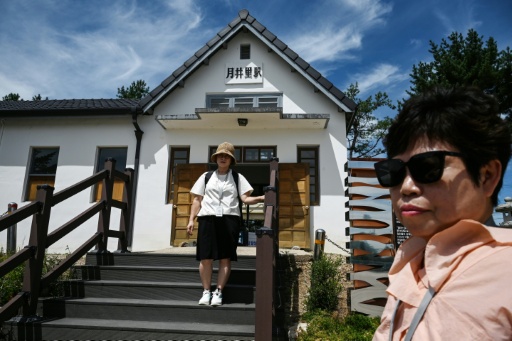 A woman poses for photos at the Woljeong-ri Station in Cheorwon, Gangwon Province in South Korea — GREG BAKER / AFP
