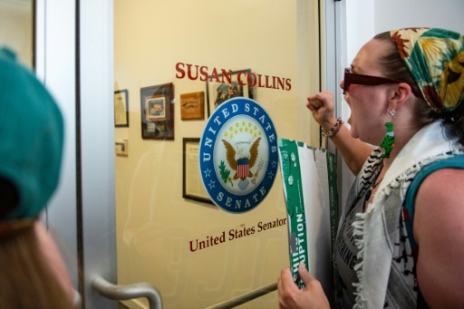 Demonstrators gathered at the office of Maine's Republican Senator Susan Collins to protest a federal agent's shooting in Biddeford, Maine