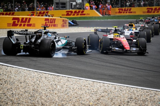 George Russell (L) loses control and crashes his Mercedes in the gravel after colliding with Ferrari's Lewis Hamilton (R) at the start of the Belgian Grand Prix — JOHN THYS / AFP