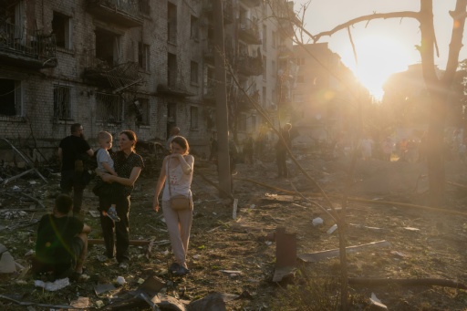 After the barrage, locals stood on the rubble of destroyed apartment blocks ripped apart by the barrage