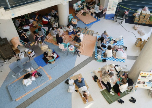 Thousands of people, many of them elderly, were escaping the heat in evacuation shelters — JIJI PRESS / AFP