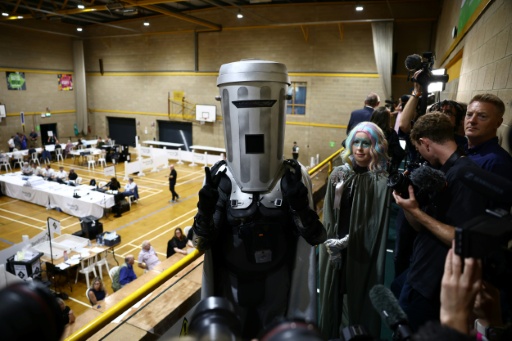 Count Binface arrives at the count centre venue for the result of the by-election for the parliamentary seat of Clacton, at Clacton Leisure Centre, eastern England on August 14, 2026 — Henry NICHOLLS / AFP