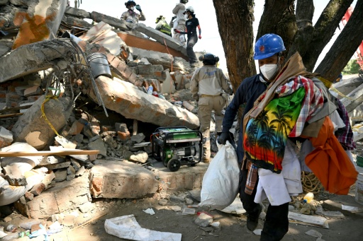 Rescuers, residents and neighbors in Cali, Colombia have been collecting personal belongings from the rubble, as emergency crews continue last-gasp efforts to locate survivors — Raul ARBOLEDA / AFP