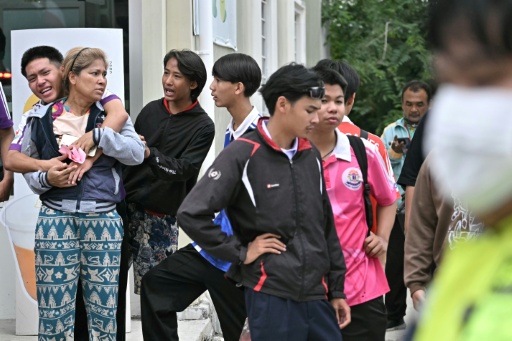 Students and parents gathered outside a school in Thailand's Nonthaburi province, just north of the capital Bangkok, after a student shot and killed five students after killing his grandparents — Lillian SUWANRUMPHA / AFP