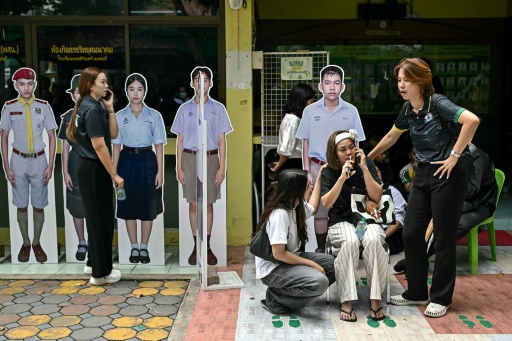 Students at a school north of the Thai capital said they started running after they saw a teen shooter walking towards their building — Lillian SUWANRUMPHA / AFP