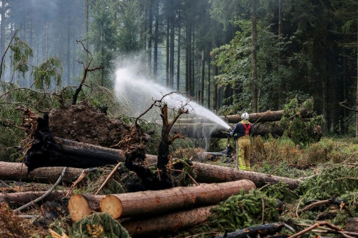 It could take weeks or months of soaking and dousing to prevent the High Fens blaze from reigniting — JULIEN WARNAND / AFP