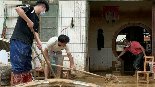 Residents and volunteers clean up following floods in China's Guangxi province