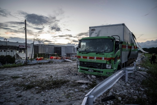 A damaged truck is seen on a debris-covered road in Japan's Kashima after a powerful earthquake — Yuichi YAMAZAKI / AFP