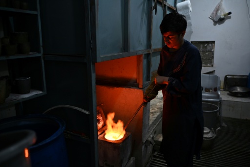 An Afghan goldsmith melting gold at a workshop in Fayzabad, in Afghanistan's northeastern Badakhshan province — OMER ABRAR / AFP