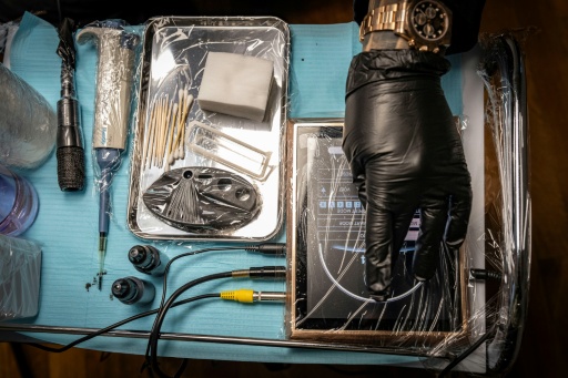 Tools and equipment used by scalp tattoo artist Remy as at his studio in Ginowan — Yuichi YAMAZAKI / AFP