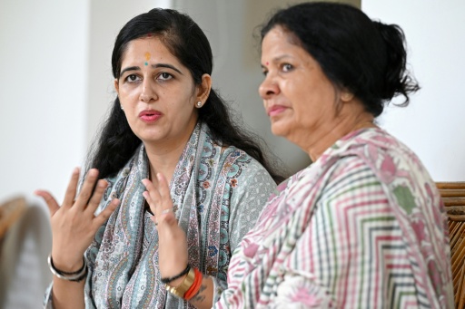 Ritu Pant (L), wife of Indian merchant navy captain Ajay Pant, speaks to AFP next to her mother-in-law Deepa Pant at Ramnagar in India's Uttarakhand state — Arun SANKAR / AFP