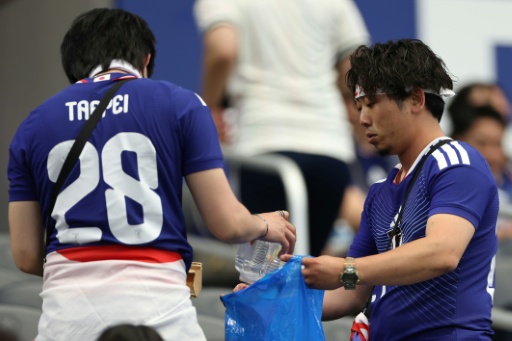 Japanese fans pick up the rubbish after their World Cup game against the Netherlands