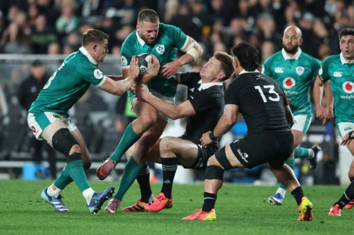 Stuart McCloskey of Ireland is tackled by New Zealand's Jordie Barrett at Eden Park — Michael Bradley / AFP