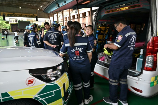 Emergency responders stand by on the school premises — Lillian SUWANRUMPHA / AFP