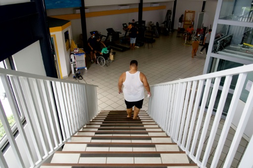 Un patient atteint d'obésité monte et descend un escalier pour améliorer son endurance et son cardio au centre de soins spécialisé Ora Ora à Pirae, en Polynésie française, le 10 septembre 2021 — Suliane FAVENNEC / AFP