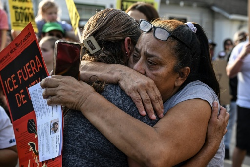 Grieving community members embraced after the slaying of Lorenzo Salgado by an ICE agent in Houston, Texas