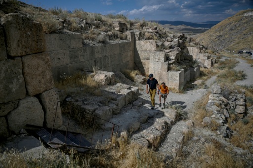 Tourists climb over the remains of the ancient fortress of Cavustepe near Van in eastern Turkey — Ozan KOSE / AFP