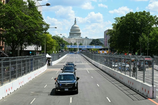 US President Donald Trump rides in the armored presidential limousine, known as "The Beast," on the 1.7-mile Washington street course ahead of the start of the IndyCar Freedom 250 Grand Prix — SAUL LOEB / AFP