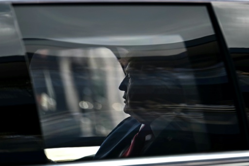 US President Donald Trump rides in the presidential limousine, known as "The Beast," on the track prior to the start of the IndyCar Freedom 250 Grand Prix in Washington — Kent NISHIMURA / AFP
