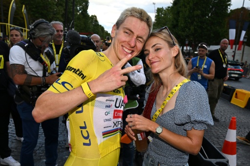 Tadej Pogacar (L) said he was looking forward to relaxing at home with his partner Urska Zigart (R) after winning a fifth Tour de France title — Dario Belingheri / AFP