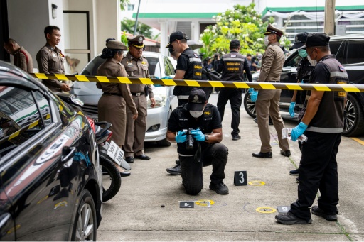 Police officers gather evidence at the scene of the shooting — Arnun Chonmahatrakool / AFP