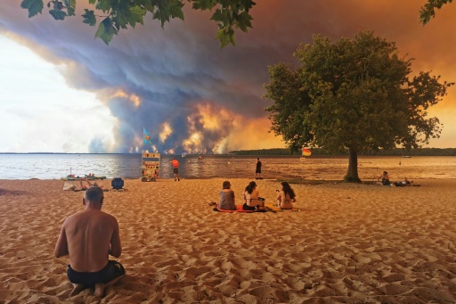 Beachgoers nearby watched the blaze in the northern part of the Arcachon Basin in Gironde, southwest France — Maximilien LAMY / AFP
