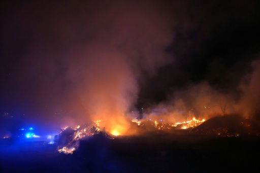 Two major blazes have merged near Madrid, with the smell of burning reaching the Spanish capital — Cesar MANSO / AFP