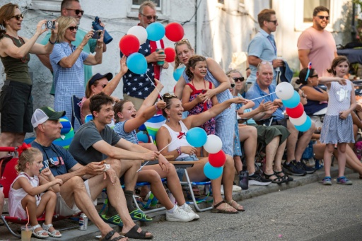 People line the streets to watch a festive parade in Gloucester, Massachusetts for the July 4 holiday