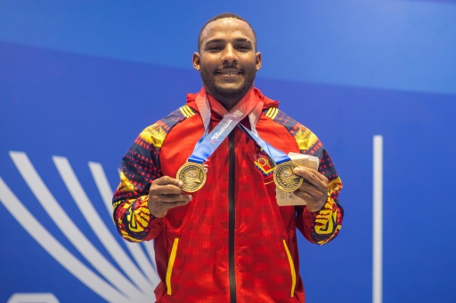 Venezuela's Julio Mayora, seen here in a handout picture from the Central American and Caribbean Games, carried cement blocks to rescue people following the twin earthquakes that struck Venezuela in June — SHENNY ESTER VASQUEZ ROSARIO / AFP