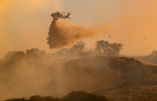 A helicopter drops water on Little Fire in Pleasanton, California on July 21, 2026 — Josh Edelson / AFP